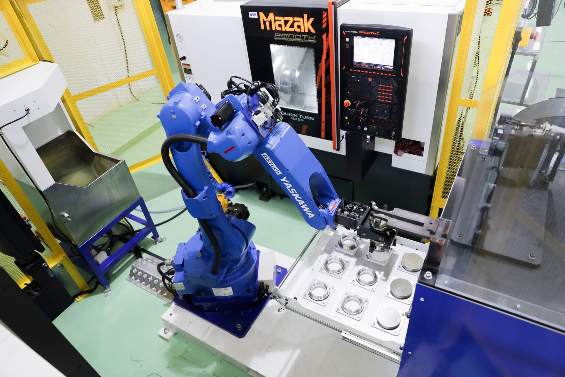 A robotic arm loading a CNC machine