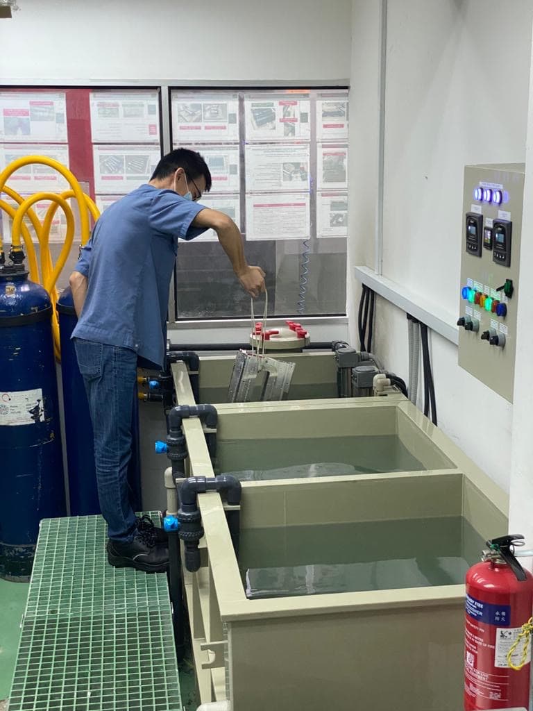 A staff performing DI water cleaning on a CNC machined part