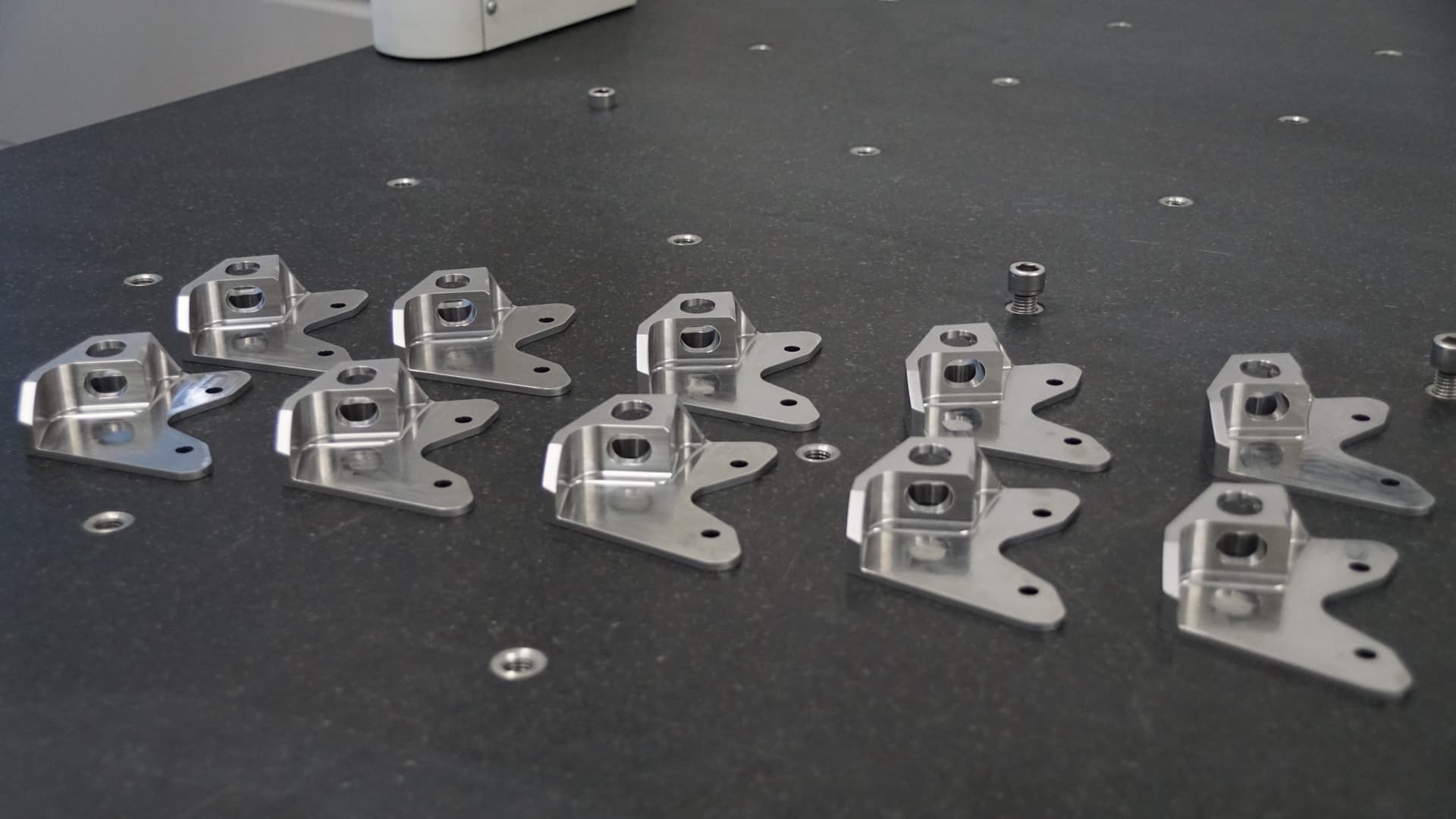 Lots of the same CNC machined part in a tray, showcasing low-volume machining