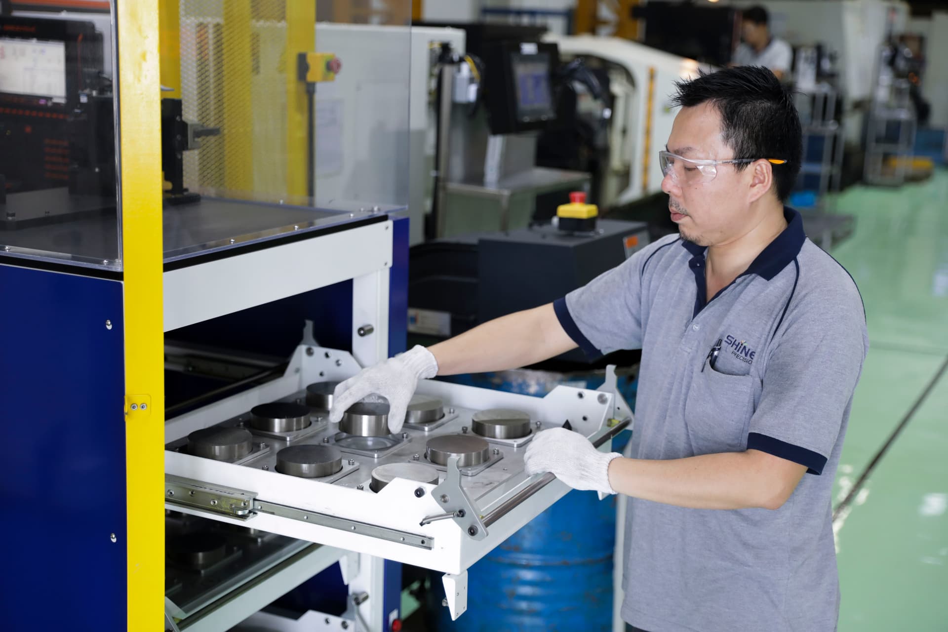 Machinist inspecting and storing finished tight-tolerance CNC machined component
