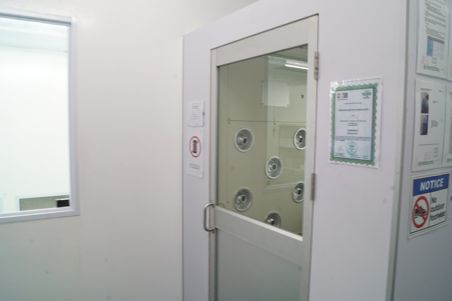 HEPA-filtered cleanroom entry air shower airlock preventing particulate contamination